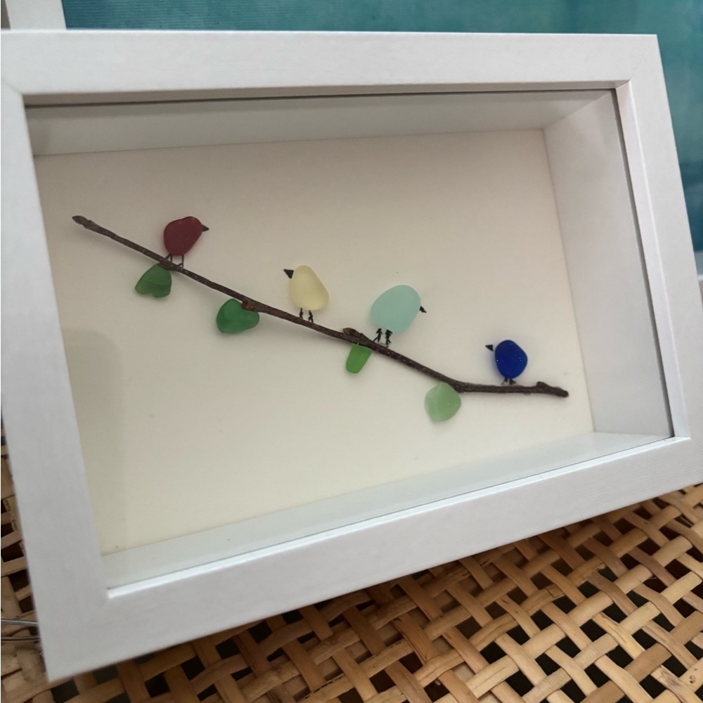 Colorful Sea glass Birds on the branch in a white shadow box frame.